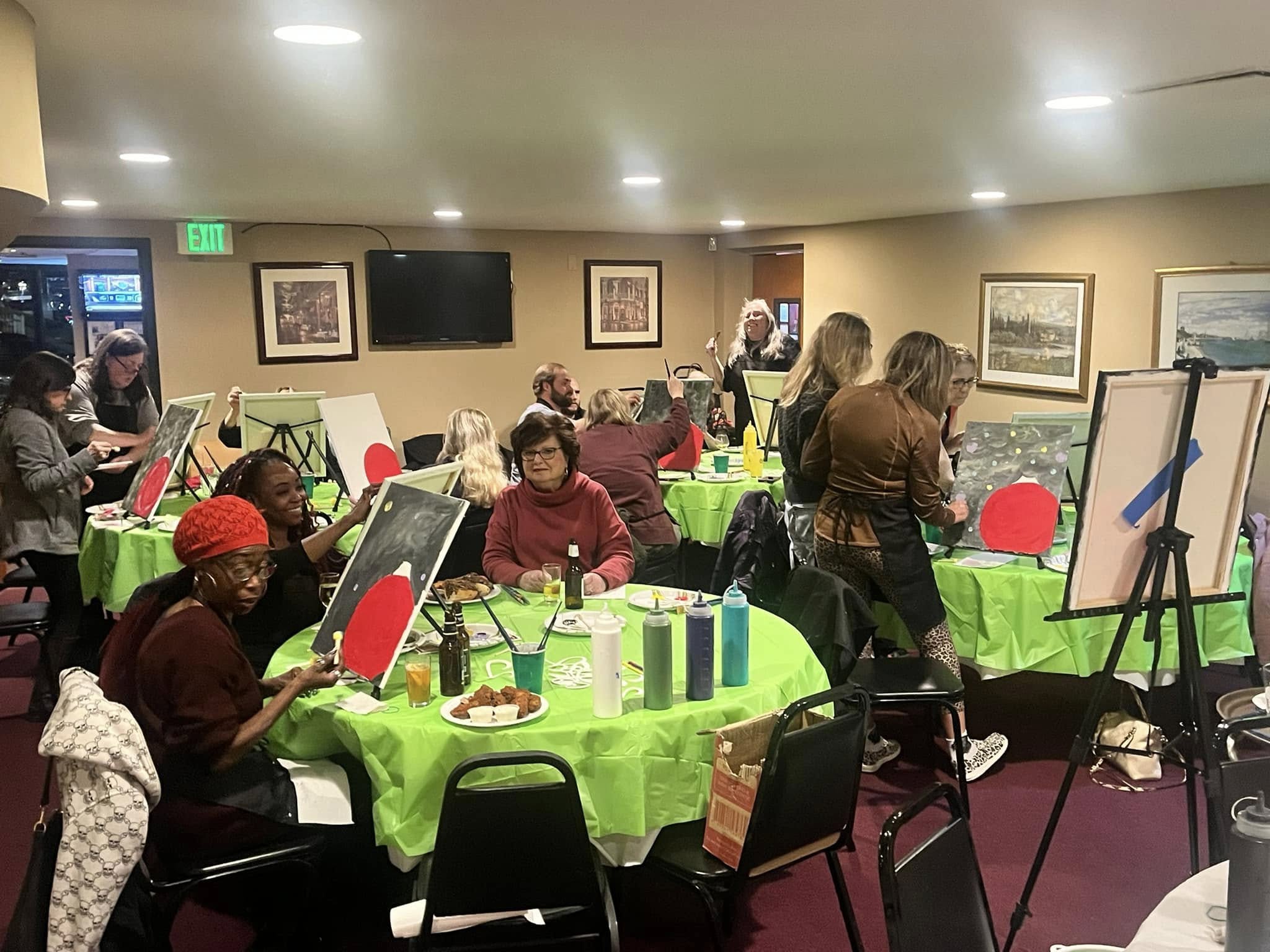 Guests enjoying a painting gathering in the Johnny Dee’s dining room